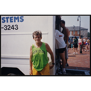 A runner poses in front of a truck during the Bunker Hill Road Race