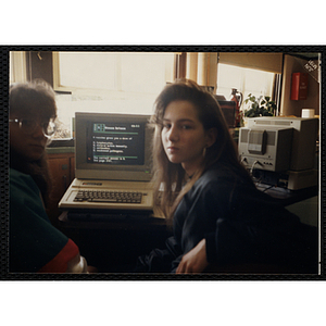 Two girls using a classroom computer to answer a multiple-choice question