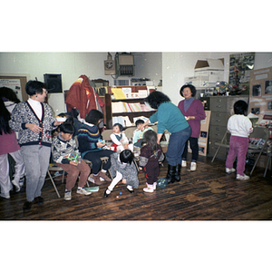 Women and children attend a holiday party for the Chinese Progressive Association