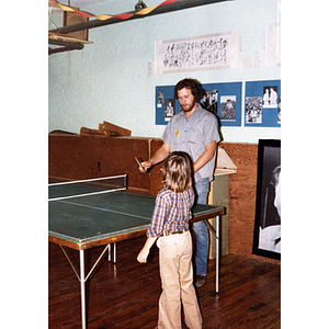 Man and boy playing ping-pong at the Chinese Progressive Association