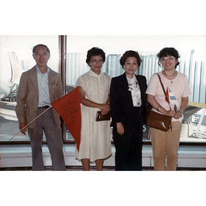 Henry Wong stands with three women in a Chinese airport