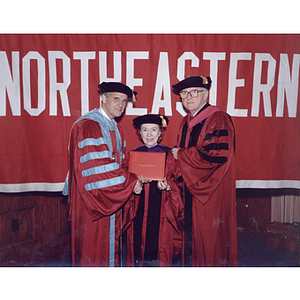 President Curry and escort Harvey Krentzman with honorary degree recipient Diana Auger