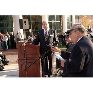 A man speaks into a microphone at the Veterans Memorial dedication ceremony