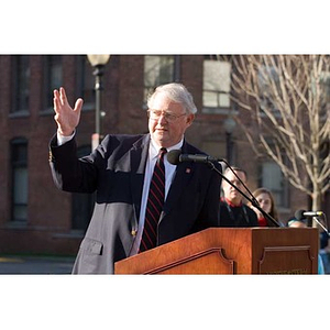 Neal Finnegan gestures while speaking at the Veterans Memorial dedication