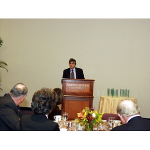 Dr. Ira R. Weiss at podium before presentations of College of Business Administration's Distinguished Service Awards