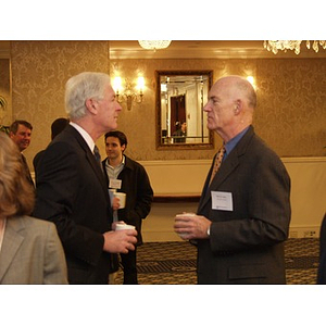 Two men talk before the College of Business Administration's CEO Breakfast Forum at The Colonnade