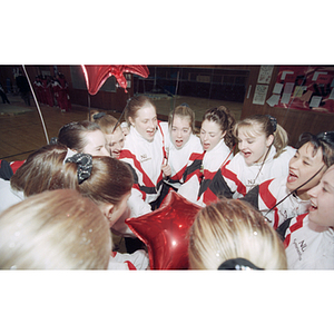 Northeastern gymnastics team members cheering before a competition