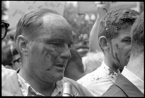 David Dellinger (left) and Staughton Lynd (partly obscured) after being splashed with red paint by counter-protesters during the Assembly of Unrepresented People anti-war march
