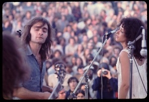 Jefferson Airplane performing at Woodstock: Marty Balin and Grace Slick on stage, with audience in background