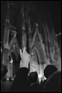 Crowd flashing V signs at the Vietnam Moratorium candlelight vigil held at St. Patrick's Cathedral