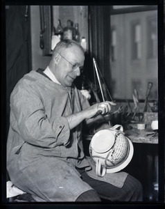 Nathan S. Hill, china repairer, working on a transferware chamber pot