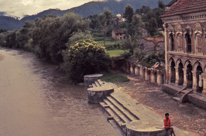 Man sitting by a river