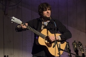 Matt Nakoa (acoustic guitar) performing in concert at the Payomet Performing Arts Center