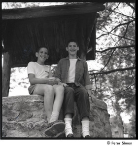 Camp Arcadia: two campers seated on a well