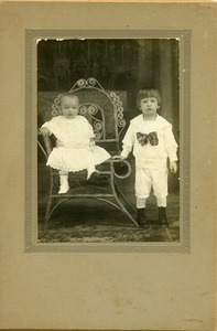 Wanda Szewczyk and her brother John: full-length studio portrait with one child seated