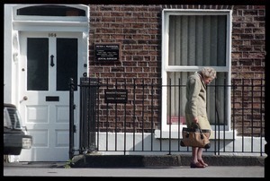 Older woman walking down a Pembroke Road, Dublin, across from the U.S. embassy