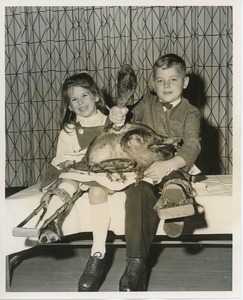 Young clients holding turkey at Thanksgiving dinner