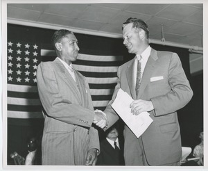 Unidentified men shaking hands at Institute Day