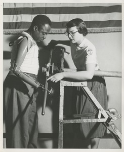 An occupational therapist and patient with a prosthetic limb