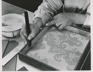 A man makes a box for the 1951 president's trophy plaque