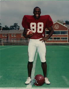 Darren Bennett standing in football uniform (class of 1995)