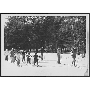 Group of adults and children cross country skiing