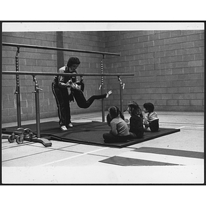 Instructor teaching children gymnastics in gym at West Roxbury branch