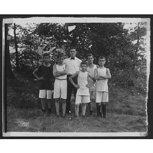 Group poses for photo outdoors at Camp School, Allston