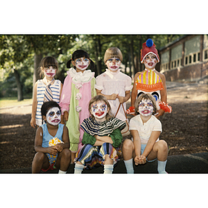 Young children dressed and made up as clowns