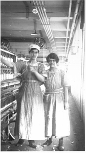 Two female textile workers at a spinning frame. [07]