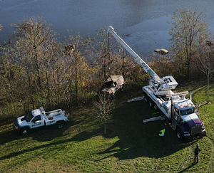 A crane lifting a vehicle from Lake Massasoit (2020)