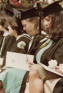 W'1977 Graduates Holding Carnations.