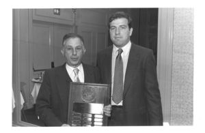 Edward Seksa, editor-in-chief of 1983-1984 Law Review, presents the Suffolk University Law School Review recognition award to Law Library Director Edward J. Bander