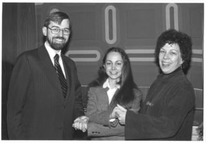 Francis X. Flannery, Janette Fasano, and Professor Frances Burke (CAS) shake hands at President Carter's Management Intern Program event at Suffolk University