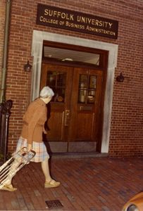 A woman walks past Suffolk University's College of Business Administration building