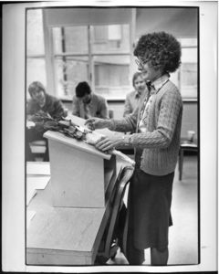 Suffolk University Professor Karen Blum (Law), holding roses at a classroom podium