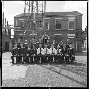 Andersonstown RUC/PSNI station, West Belfast. Shots taken just before it was demolished. A group of the station's officers pose for the last group photograph within the walls of the compound before vacating the base. Their police station in the background (now demolished) remained hidden behind high security walls for most of the "Troubles." Images taken in the years immediately following the change from RUC to PSNI.