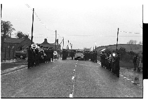 Funeral of an RUC officer murdered by the PIRA, Castlewellan, Co. Down. Shots of RUC band