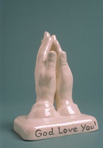 Statuette of two hands clasped in prayer