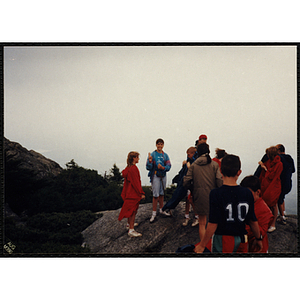 A group of youth stand at the top of the White Mountains