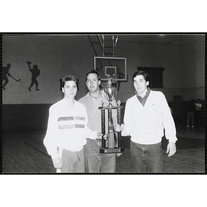 Three Boys & Girls Club members posing with their basketball tournament trophy