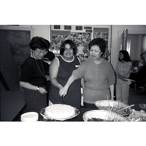 Suzanne Lee and others cut cake at an event