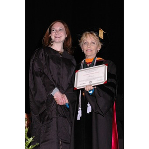 Dean Carole Kenner presents an award to Molly Clancy at the School of Nursing convocation ceremony