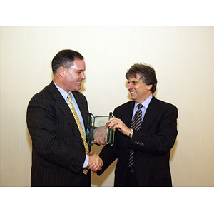 Joseph Malarny, CBA '82, accepts the College of Business Administration's Distinguished Service Award from Dr. Ira R. Weiss, right