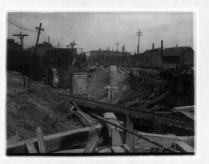 View of railroad tracks going through construction of wood beams