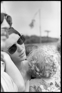 Mother and infant daughter in the audience, waiting to see Taj Mahal in concert, Newport Folk Festival