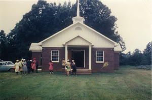 Church members in front of rebuilt Antioch Church, Blue Mountain, Miss.
