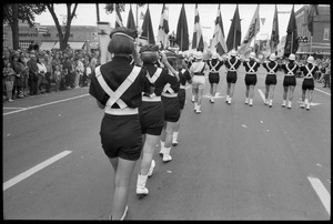 All-woman drill team in the parade for Robert F. Kennedy's visit, marching down 10th Street during the Turkey Day parade