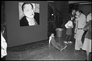 Child sprawled on the floor in front of Andy Warhol's unveiled portrait of Charles Ireland at a reception at the Birmingham Museum of Art