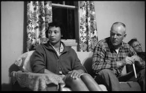 Mildred and Richard Loving seated on a couch with Richard's father (from left)